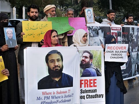 Pakistani families hold pictures of their missing family members during a demonstration to mark World Human Rights Day in Islamabad, Pakistan, Tuesday, Dec. 10, 2019. 
Dozens of Pakistanis whose relatives were allegedly detained by security agencies in recent years Tuesday urged prime minister Imran Khan Khan to immediately order the release of their loved ones, as activists observed Human Rights Day across the country. (AP Photo/A.H. Chaudary)