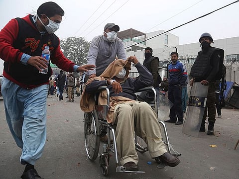 A patient is transferred after angry lawyers staged an attack on a hospital in Lahore, Pakistan, Wednesday, Dec. 11, 2019.