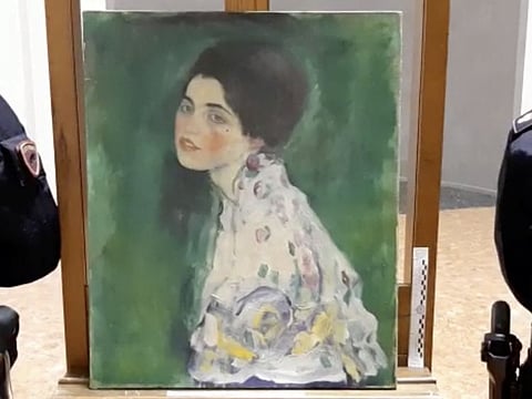 Italian police stand next to what they say is a masterpiece by Austrian artist Gustav Klimt "Portrait of a Lady" that was stolen in 1997 and was found hidden in an outside wall of an Italian gallery, in Piazcenza, Italy December 10, 2019 in this still image taken from a video. Polizia di Stato/Handout via REUTERS   ATTENTION EDITORS - THIS IMAGE HAS BEEN SUPPLIED BY A THIRD PARTY. NO RESALES. NO ARCHIVES.