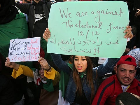 Demonstrators shout slogans during a protest calling to reject the presidential election in Algiers, Algeria December 11, 2019.