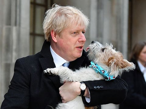 Boris Johnson and his dog after voting in the UK election on Thursday.