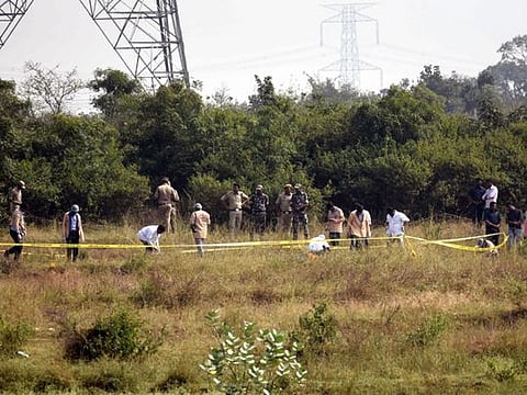 Police officers stand guard at the spot where accused in the rape and murder of the woman veterinarian were killed in an encounter, in Hyderabad 
