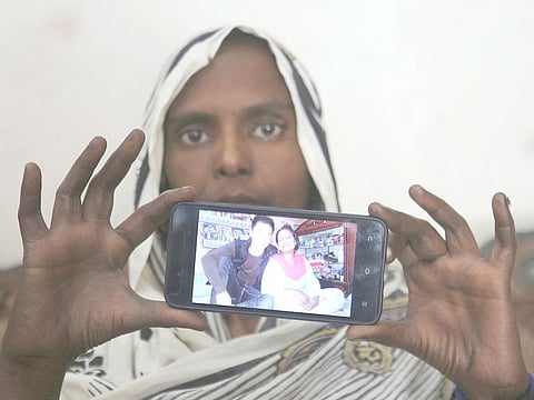 Pakistani Christian woman Samiya David shows her picture with Chinese husband, in Gujranwala, Pakistan. Samiya had been in China just two months when her brother got a phone call telling him to pick her up at the airport. When he arrived, he found Samiya in a wheelchair, malnourished and too weak to walk, said her cousin Pervaiz Masih. She died barely five weeks later. Masih was among the relatives who prepared Samiya's grave and attended her burial in May. 