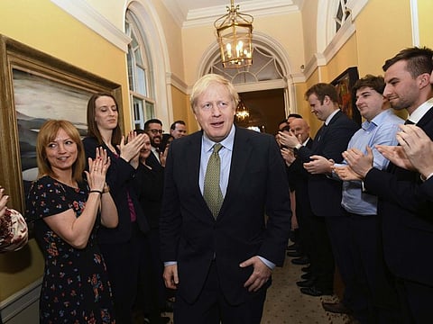 Boris Johnson is greeted by staff as he returns to 10 Downing Street, London, on December 13, 2019.  