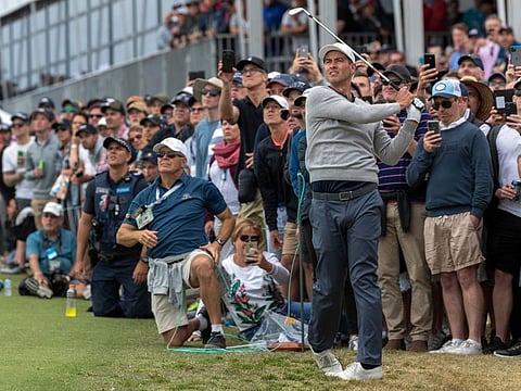 International team's Adam Scott of Australia follows his approach shot to the 10th green at the Presidents Cup golf in Melbourne 