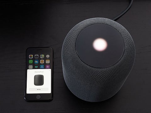 An Apple HomePod syncing to a smartphone.