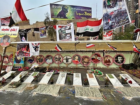 Symbolic graves and posters of anti-government protesters who have been killed in demonstrations are displayed in Tahrir Square, during ongoing protests in Baghdad, Iraq, Sunday, Dec. 15, 2019. 