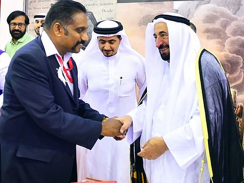 Long-time UAE resident Manayil Fasal receiving a handshake from His Highness Dr Shaikh Sultan Bin Mohammad Al Qasimi, Supreme Council Member and Ruler of Sharjah at the Sharjah International Book Fair (SIBF) in November. 