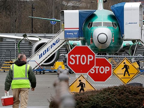 A Boeing worker walks in view of a 737 MAX