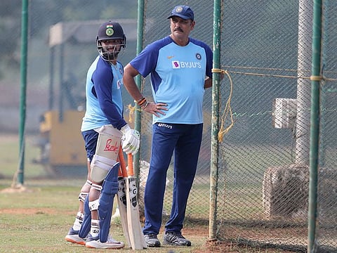 India's Rishabh Pant, left, stands with head coach Ravi Shastri after batting in the nets during a training session ahead of their second one day international cricket match against West Indies in Visakhapatnam, India, Tuesday, Dec. 17, 2019.