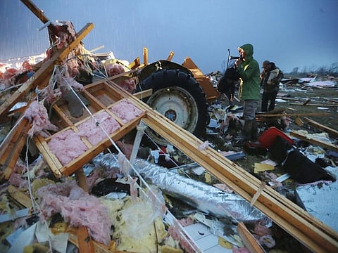 Guntown: Shane Keith and other volunteers help search debris and try to salvage what they can from their church that was completely destroyed in a tornado that touched down in Guntown, Miss., on Monday.