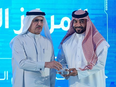 Saeed Mohammed Al Tayer, MD & CEO of DEWA, honours Abdul Rahman Essa Al Muheiri on behalf of his sister Amal Essa Al Muheiri, first prize, during the award ceremony of third ‘Ideal Home’ initiative 2019 at V Hotel Dubai, Curio Collection by Hilton in Dubai. 18th December 2019. Photo: Ahmed Ramzan/ Gulf News