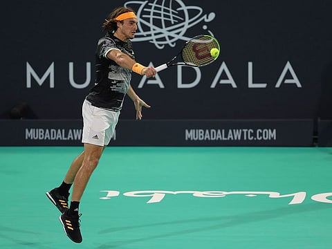 Stefanos Tsitsipas  returns the ball to Novak Djokovic during their semi-final of the Mubadala World Tennis Championship in Abu Dhabi.