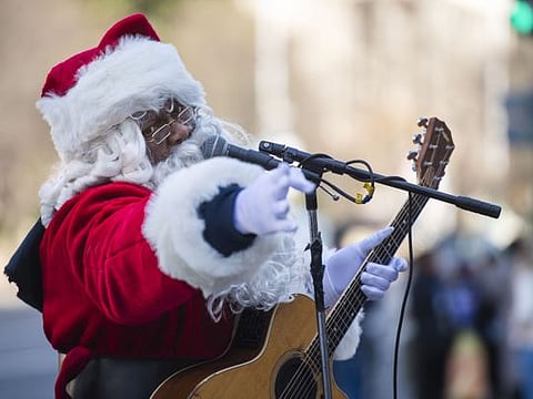 Antonio “Tony” Covay, who advertised himself on Craigslist as “Singing Black Santa,” performs last week outside the Smithsonian National Museum of Natural History. MUST CREDIT: Photo by Amanda Voisard for The Washington Post.