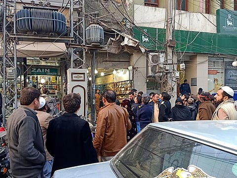 People gather outside buildings following an earthquake tremor in Peshawar, Pakistan December 20, 2019. 