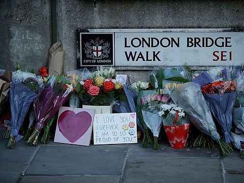 In this Monday, Dec. 2, 2019 file photo, tributes are placed by the southern end of London Bridge, three days after a man stabbed two people to death and injured three others before being shot dead by police, in London.
