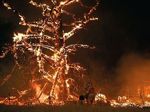 NSW Rural Fire Service crew fight the Gospers Mountain Fire as it impacts a property at Bilpin, New South Wales state, Australia. 