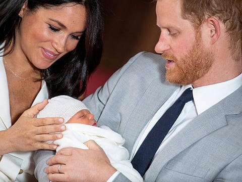 FILE PHOTO: Britain's Prince Harry and Meghan, Duchess of Sussex hold their baby son, who was born on Monday morning, during a photocall in St George's Hall at Windsor Castle, in Berkshire, Britain May 8, 2019. Dominic Lipinski/Pool via REUTERS/File Photo