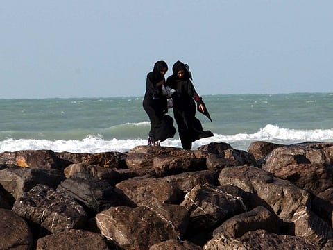 UAE residents embrace the refreshing weather at Sharjah Beach, unfazed by gusty winds and rough seas.
