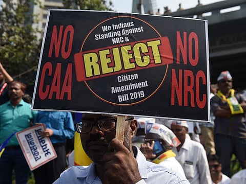 A protester holds a placard during a demonstration against India's new citizenship law in Mumbai on Wednesday.