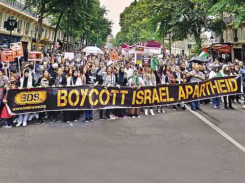 Anti-Israel demonstrators march behind a banner of the BDS organisation in Marseilles, France 