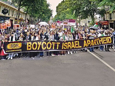 Anti-Israel demonstrators march behind a banner of the BDS organisation in Marseilles, France 