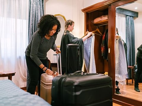 Girls just arriving in the hotel and unpacking clothes
