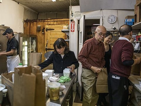 Owners Faye Lee Sit, center left, and her husband Tom Sit, center right, at work at their restaurant, Eng's, in Kingston, N.Y., Dec. 14, 2019. Across the country, owners of Chinese-American restaurants like Eng’s are ready to retire but have no one to pass the business to because their children, educated and raised in the United States, are pursuing careers that do not demand the same grueling labor as food service. (Lauren Lancaster/The New York Times)