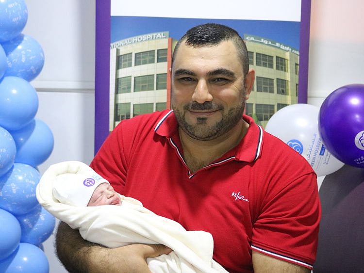 NAT 200101 Baby Joseph with Father Romeo Sheha 2 Bareen International Hospital-1577871330091