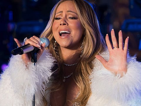 (FILES) In this file photo taken on December 31, 2017, singer Mariah Carey performs during New Year's Eve celebrations in Times Square in New York. Carey has had a long list of hits over the years, but her classic holiday song has helped her make history as the first artist to top the Billboard charts in four separate decades. "All I Want For Christmas Is You" is atop the Billboard Hot 100 for the week dated January 4, 2020, based on sales, radio airplay and streaming data -- its third week atop the rankings. That means Carey has had a number one single in the 1990s, 2000s, 2010s and 2020s. / AFP / DON EMMERT