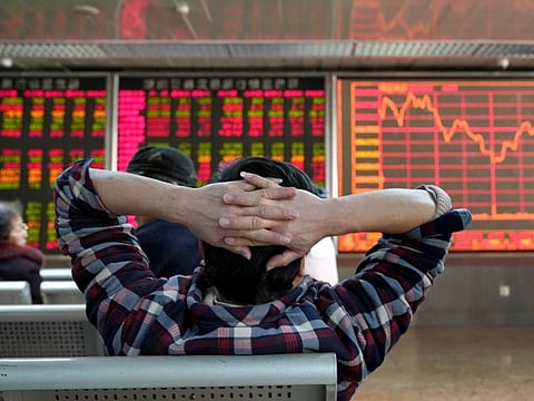 An investor looks at a stock quotation board at a brokerage office in Beijing, China January 3, 2020. REUTERS/Jason Lee