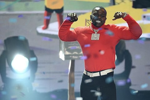 FILE-In this Sunday, June 23, 2019 file photo, DaBaby performs "Sugar" at the BET Awards, at the Microsoft Theater in Los Angeles. Grammy-nominated rapper DaBaby was arrested on a battery charge in Miami on Thursday night Jan. 2, 2020, and is being held on an arrest warrant out of Texas, according to court records.(Photo by Chris Pizzello/Invision/AP, File)