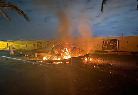 A destroyed vehicle on fire following a US strike on January 3, 2020 on Baghdad international airport road in which top Iranian commander Qasem Soleimani was killed along with eight others. 