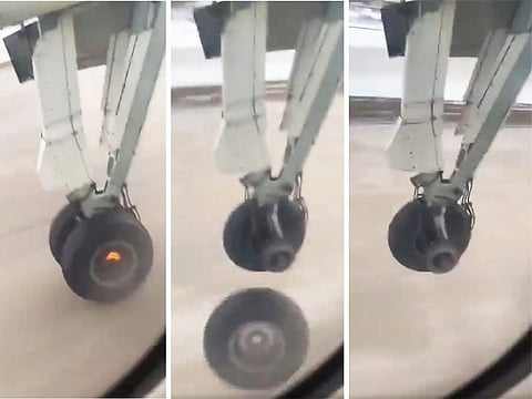 A combination picture using screengrabs of a video showing an Air Canada plane wheel catching fire and falling off during takeoff in Canada