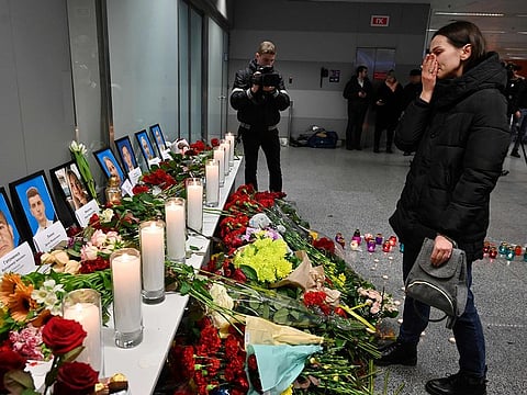A woman reacts in front of a memorial for the victims of the Ukraine International Airlines Boeing 737-800 crash in the Iranian capital Tehran, at the Boryspil airport outside Kiev on January 8, 2020. 