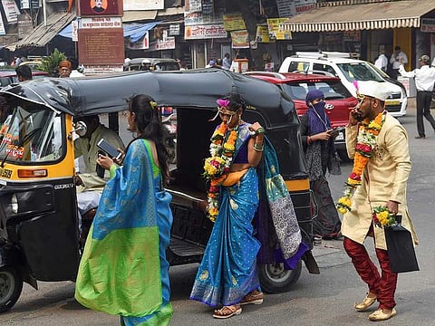 A bride and groom arrive at a marriage hall in Mumbai. 