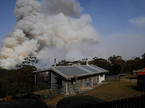 NSW Rural Fire Service crews watch on as a fire burns in bushland close to homes at Penrose in the NSW Southern Highlands, south of Sydney, Australia, January 10, 2020.