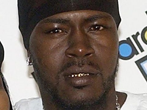 In this Friday, Aug. 8, 2003, file photo, rapper Trick Daddy, right, poses with a member of the group Escape as he arrives at the 2003 Billboard R&B Hip Hop Awards in Miami Beach, Fla.