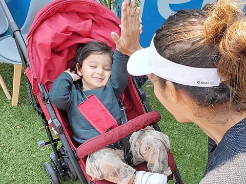 Sania Mirza does a high five with her son, Izhaan, after her doubles win at Hobat International today.