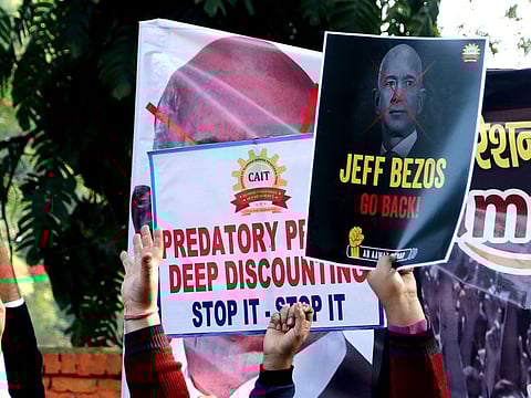 Traders hold placards during a protest against the visit of Amazon's founder and CEO Jeff Bezos, in New Delhi on Wednesday. 