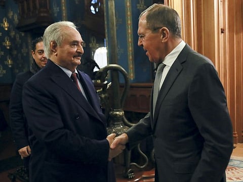 In this handout photo released by Russian Foreign Ministry Press Service, Russian Foreign Minister Sergey Lavrov, right, shakes hands with Khalifa Haftar, the head of the Libyan National Army prior to talks in Moscow, Russia, Monday, Jan. 13, 2020. 