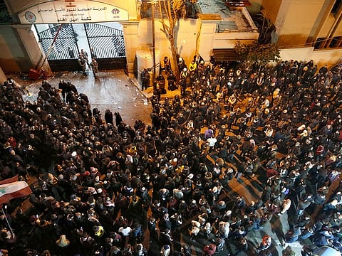 Anti-government protesters gather outside a police headquarters, as they demand the release of those taken into custody the night before in Beirut, Lebanon, Wednesday, Jan. 15, 2020
