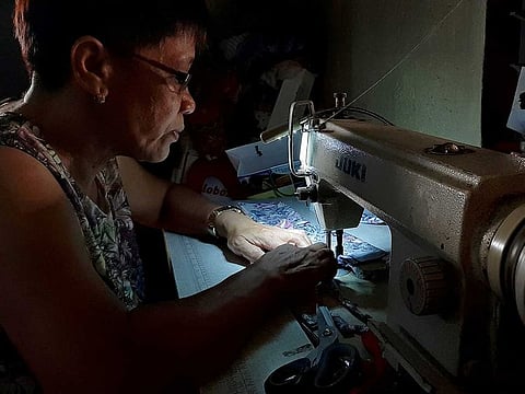 A seamstress sews protective masks to be donated to residents affected by the erupting Taal Volcano in Lipa, Batangas.