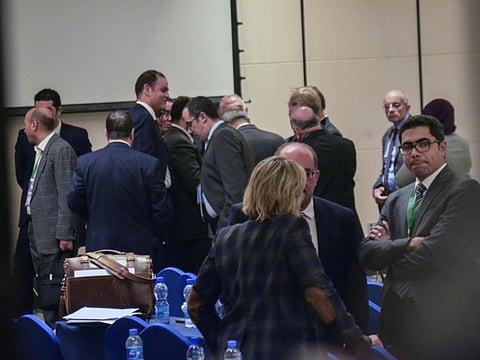 Delegates discuss amongst themselves after a closed-door session at the end of the fourth and final round of talks between Ethiopia, Egypt and Sudan on Ethiopia's construction of a controversial dam on the Nile River, in Addis Ababa, Ethiopia Thursday, Jan. 9, 2020. 
