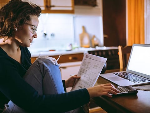 Woman going through bills at home