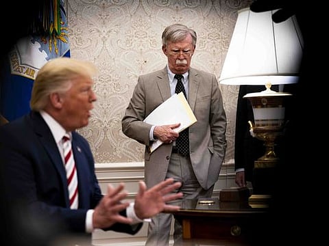 John Bolton, the then national security adviser, watches President Donald Trump in the Oval Office, at the White House in Washington on August 20, 2019. 