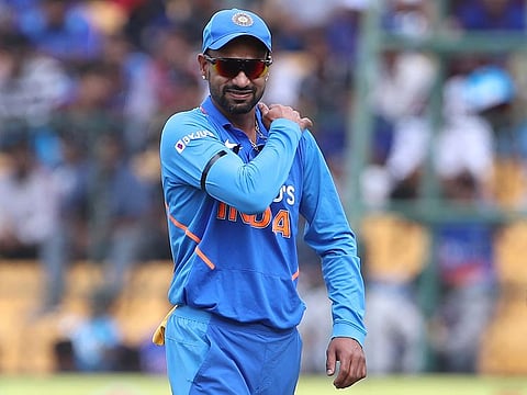Shikhar Dhawan holds his shoulder as he leaves the ground after getting hurt while fielding during the third one-day international against Australia in Bangalore, on January 19, 2020. 