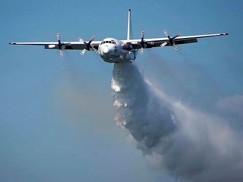 A C-130 Hercules plane called "Thor" drops water during a flight in Australia. 