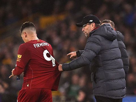 Jurgen Klopp and Roberto Firmino.
