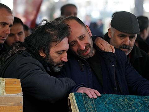 Men mourn during a funeral for earthquake victims in Elazig, Turkey, January 26, 2020.
